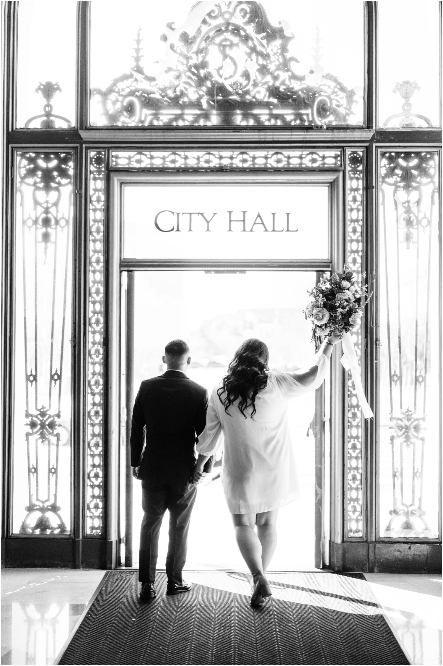 Black and white photo of couple leaving City Hall
